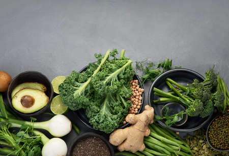 Assorted green vegetables and cereal on gray background. Healthy food concept. Top view, copy spaceの写真素材