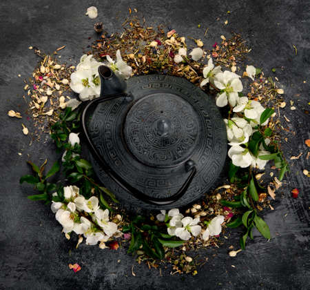 Green herbal tea with cups and teapot on gray backround. Top view, copy spaceの写真素材