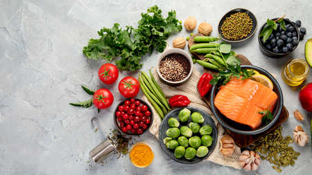 Selection of healthy food on light gray background. Clean eating concept. Top view, flat lay, copy spaceの写真素材