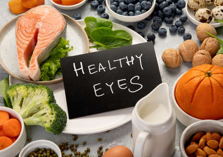 Food for eyes health. Foods that contain vitamins, nutrients, minerals and antioxidants. Top view, copy spaceの写真素材