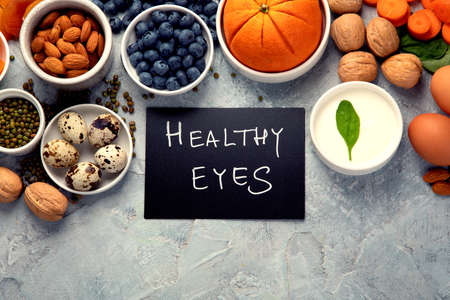 Food for eyes health. Foods that contain vitamins, nutrients, minerals and antioxidants. Top view, flat lay, copy spaceの写真素材
