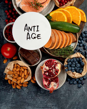 Anti aging menu on dark gray background. High in antioxidants, minerals and vitamins. Top view, flat lay, copy spaceの写真素材