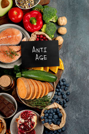 Anti aging menu on dark gray background. High in antioxidants, minerals and vitamins. Top view, flat lay, copy spaceの写真素材