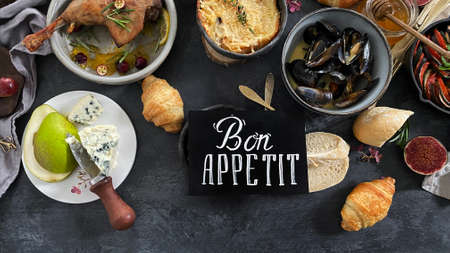 French dishes and appetizers served on dark background. Traditional food concept. Top view, flat lay, copy spaceの写真素材