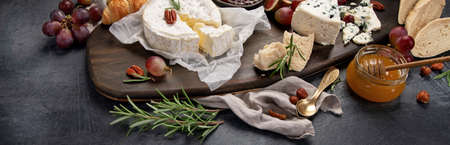 Cheese assortment on dark background. Frech cuisine concept. Copy space