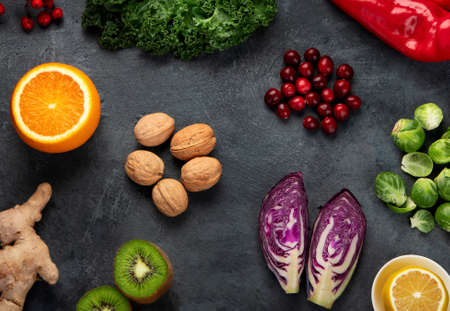 Foods high in vitamin C on dark background. Healthy diet concept. Top view, flat lay, copy space
