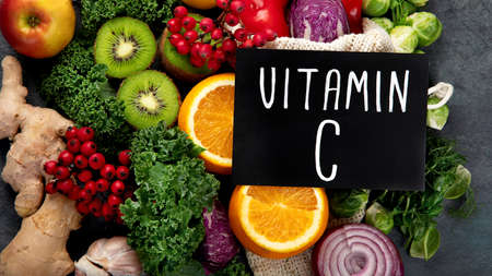 Foods high in vitamin C on dark background. Healthy diet concept. Top view, flat lay, copy spaceの写真素材