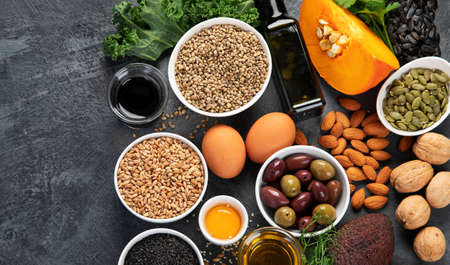 Foods high in vitamin E on dark background. Healthy diet concept. Top view, flat lay, copy spaceの写真素材