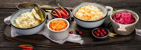 Pickled vegetables on wooden background. Salting vegetables. panoramaの写真素材