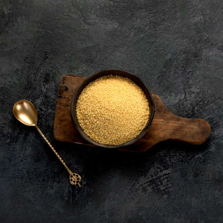 Couscous on dark background. Traditional whole grain. Top view, flat layの写真素材