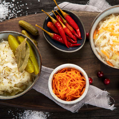 Pickled vegetables on wooden background. Salting vegetables. Top view, flat layの写真素材