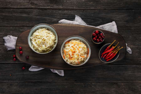 Sauerkraut on wooden background. Salting vegetables. German traditional food concept. Top view, flat lay, copy spaceの写真素材