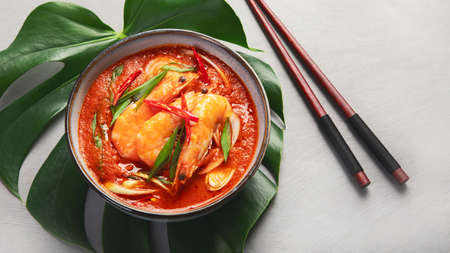 Red curry with chicken in bowl on light gray background. Traditional Asian food. Top view, flat lay, copy spaceの写真素材