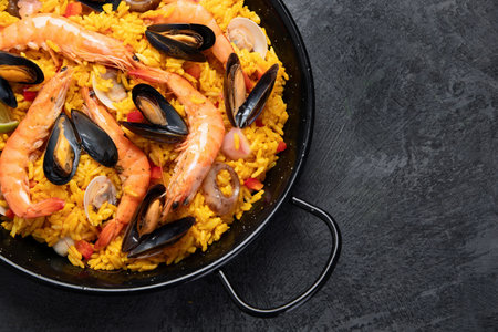 Seafood Paella on gray background. Mediterranean diet. Traditional food concept. Flat lay, top view, copy spaceの写真素材