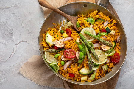 Vegan Paella on gray background. Mediterranean diet. Healthy food concept. Flat lay, top view, copy spaceの写真素材