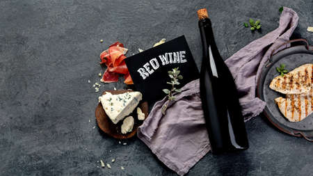 Red wine Sirah with appetizers on gray background. Traditional alcohol drinks. Top view, flat lay, copy spaceの写真素材
