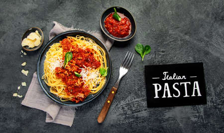 Spaghetti Bolognese on gray background. Traditional Italian pasta. Homemade food concept. Top view,...