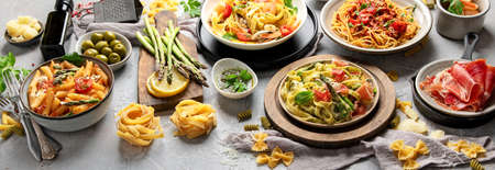 Pasta assortment on gray background. Traditional Italian Food concept. Panorama