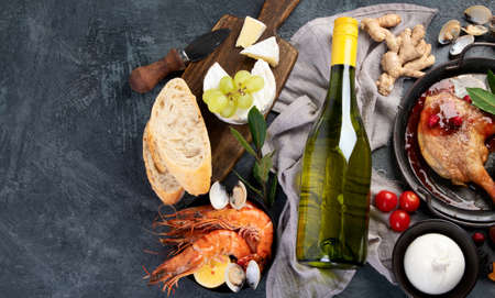 White wine Riesling with duck and snacks. Traditional alcohol drinks. Top view, flat lay, copy spaceの写真素材