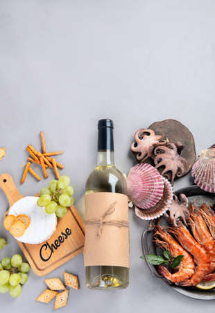 White wine bottle on gray background. Seafood and appetizers. Top view, flat lay, copy spaceの写真素材