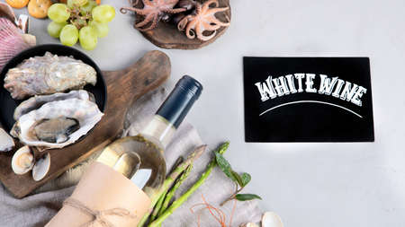 White wine bottle on gray background. Seafood and appetizers. Top view, flat lay, copy spaceの写真素材