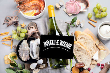 White wine bottle on gray background. Seafood and appetizers. top view, flat layの写真素材