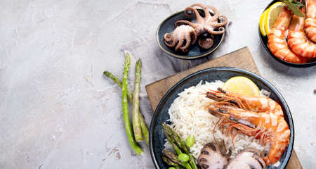 Shrimps with rice on light gray background. Mediterranean diet concept. Flat lay, top view, copy...