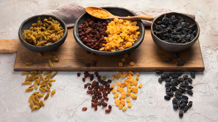 Different types of raisins on light background. Dried Fruits.の写真素材