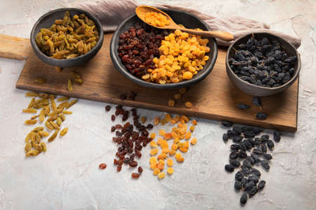Different types of raisins on light background. Dried Fruits.の写真素材