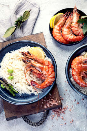 Shrimps with rice on light gray background. Mediterranean diet concept. Flat lay, top viewの写真素材