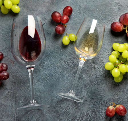 Different wine glasses on gray background. Summer drink for party, wine shop or wine tasting concept. Flat lay, top view, copy spaceの写真素材