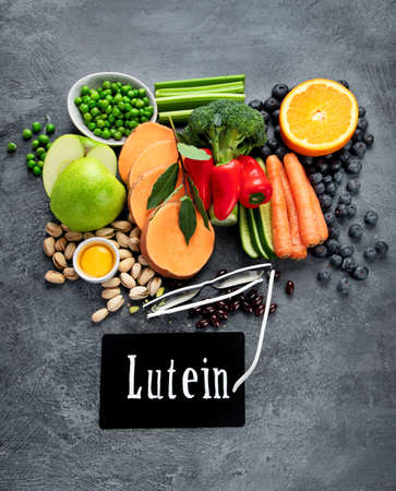 Foods high in lutein on dark background. Food for healthy eyes. High in antioxidants, minerals and vitamins. Top view, flat lay, copy spaceの写真素材