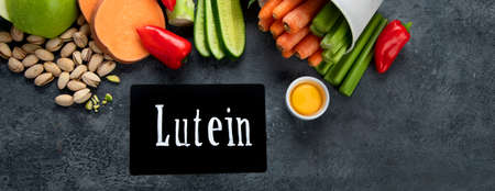 Foods high in lutein on dark background. Food for healthy eyes. High in antioxidants, minerals and vitamins. Top view, flat lay, copy space, panoramaの写真素材
