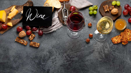 Red wine with appetizers on gray background. Summer drink for party, wine shop or wine tasting...