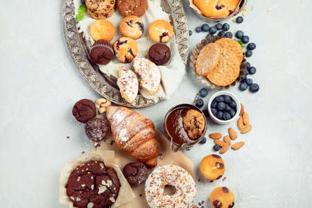 Dessert table with all kinds of snacks on light background. candy bar. Celebration concept. Top view, flat lay, copy spaceの写真素材