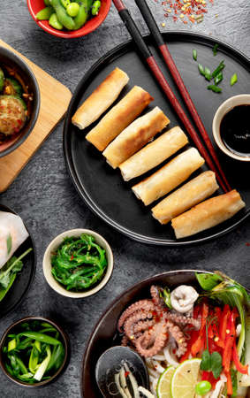 Asian food on dark background, top view.