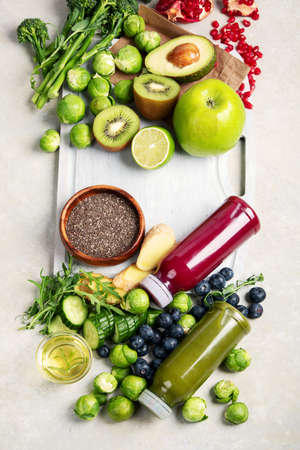 Assorted detox smoothie juices on light background. Healthy diet concept. Delicious vegetables and fruits. Top view, flat lay, copy spaceの写真素材