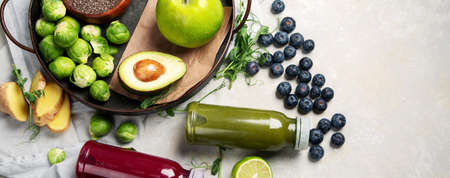 Assorted detox smoothie juices on light background. Healthy diet concept. Delicious vegetables and fruits. Top view, flat lay, copy space, panoramaの写真素材
