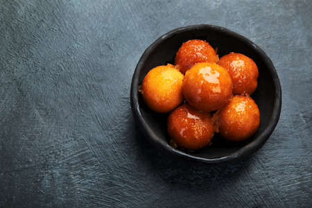 Gulab Jamun on gray background. Traditional oriental food concept. Indian sweet snacks. Top view, flat lay, copy spaceの写真素材