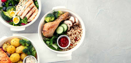 Healthy meal prep in lunch boxes on light background. Dieting eating concept. Flat lay, top view, copy spaceの写真素材