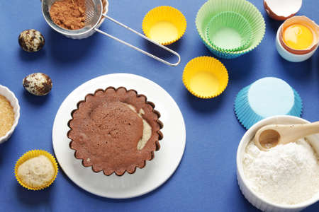 Freshly baked cake on blue background. Homemade food concept. top view, flat lay
