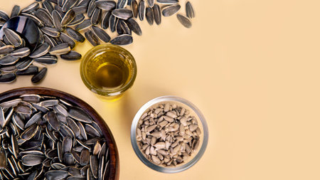 Sunflower oil and sunflower seeds on colorfull background. organic concept. Healthy food and fats. Top view, copy space, flat layの写真素材