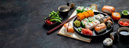 Sushi assortment on dark background. Japanese traditional luxury meal. copy space, panoramaの写真素材
