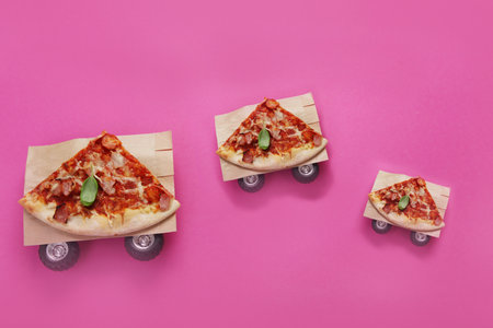 Pizza on pink background. creative conception. food delivery. Top view, flat lay, copy spaceの写真素材
