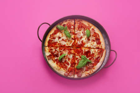 Pizza on pink background. creative conception. food delivery. Top view, flat lay, copy spaceの写真素材