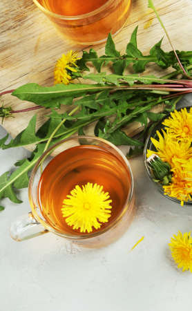 Delicious healthy tea made of dandelion flowers. Fragrant fresh herbs. Flat lay, top view, copy spaceの写真素材