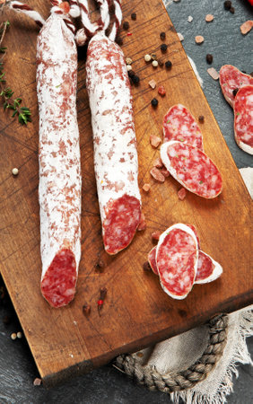 Traditional Spanish fuet on gray background. Dry cured pork sausages with a peculiar taste. Flat...