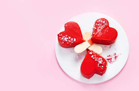 Red strawberry ice-cream on pink background. Atmospheric sweet menu concept. Top view, flat lay,...