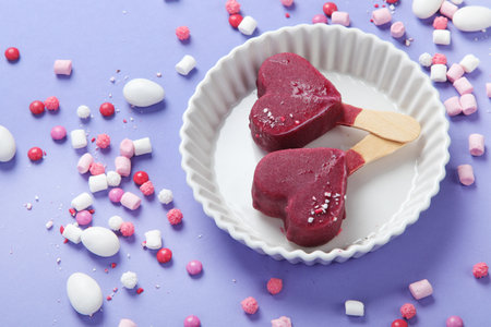 Violet blueberry ice-cream on lilac background. Atmospheric sweet menu concept.