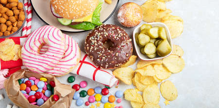 Various of american food, French fries, hamburgers, nuggets, hotdog, chips, popcorn, sauces on a...